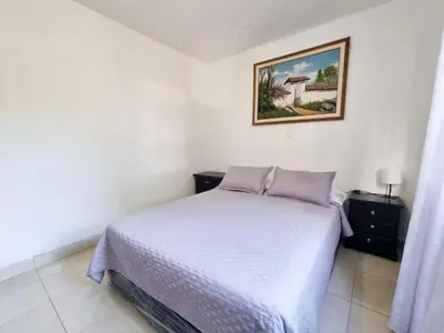 a bedroom with a bed and a picture on the wall at Hostal Casa Coliving Laureles Medellin in Medellín