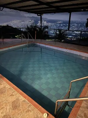 a swimming pool with a view of the city at Villa with Spectacular Medellin View with Pool and Mini Basket-Futbol Field in Medellín