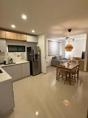 a kitchen and living room with a table and a refrigerator at Confortable y acogedor apartamento en Itagüi in Itagüí