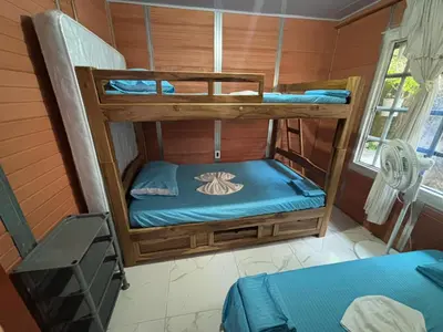 a room with two bunk beds with blue sheets at Casa Amoblada Acogedora para familias in Norcasia