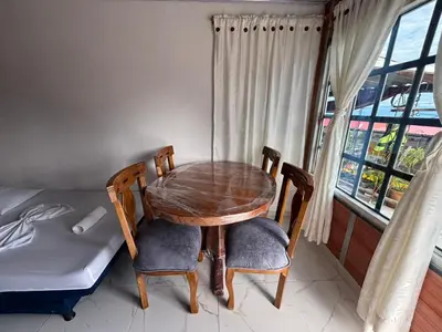 a table and chairs in a room with a bed at Casa Amoblada Acogedora para familias in Norcasia