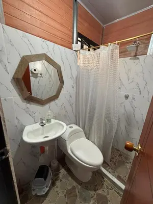 a bathroom with a toilet and a sink and a mirror at Casa Amoblada Acogedora para familias in Norcasia