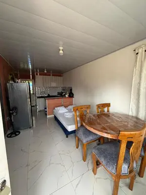 a room with a table and chairs and a bed at Casa Amoblada Acogedora para familias in Norcasia