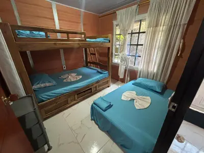 two bunk beds in a room with blue sheets at Casa Amoblada Acogedora para familias in Norcasia