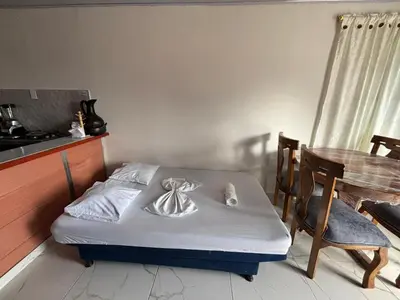 a small bed in a room with a table at Casa Amoblada Acogedora para familias in Norcasia