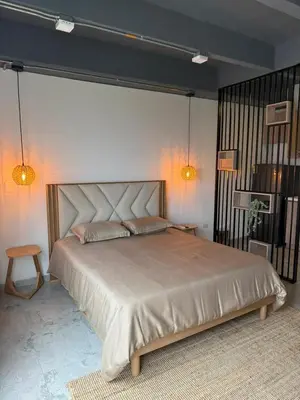 a bedroom with a large bed in a room at Loft cerca metro Floresta y Estadio - Aire acondicionado in Medellín