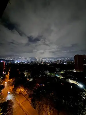 a view of a city at night with lights at Loft cerca metro Floresta y Estadio - Aire acondicionado in Medellín
