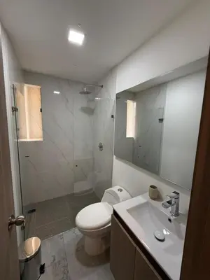 a bathroom with a toilet and a sink and a shower at Loft cerca metro Floresta y Estadio - Aire acondicionado in Medellín