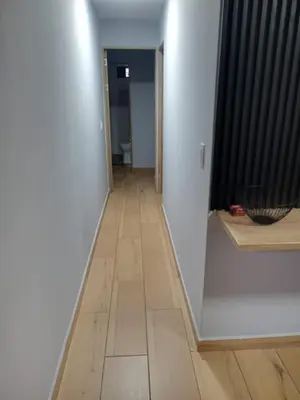 a hallway with a floor with a room with at Apartamentos laureles Estadio in Medellín