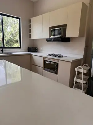 a kitchen with white cabinets and a stove top oven at Linda Vista in Rionegro