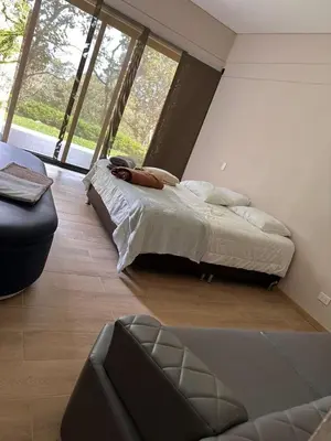 a bedroom with a bed and a large window at Linda Vista in Rionegro