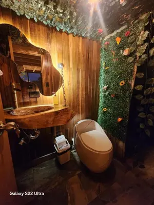 a bathroom with a toilet and a sink at Aguapá Glamping in Guarne