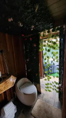 a bathroom with a toilet and a large window at Aguapá Glamping in Guarne