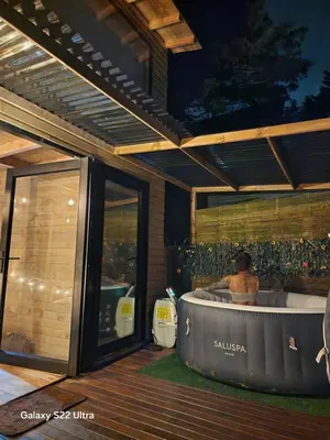 a woman sitting in a hot tub on a deck at Aguapá Glamping in Guarne