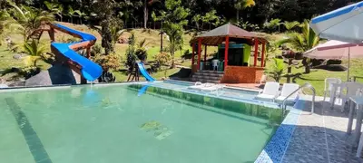 a person on a slide in a swimming pool at Finca Las Palmas - San Luis in San Luis