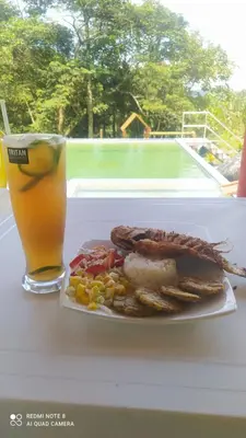 a plate of food and a drink on a table at Finca Las Palmas - San Luis in San Luis