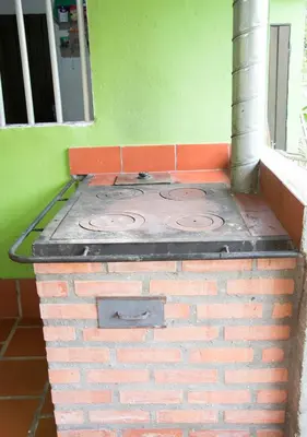 an outdoor brick stove in a green room at Finca Las Palmas - San Luis in San Luis