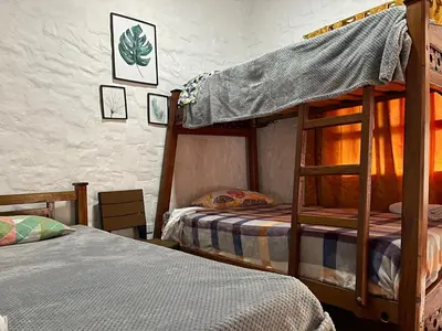 a bedroom with two bunk beds in a room at Hotel Casa Campestre in Jardin