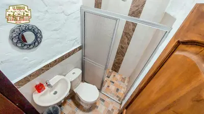 a bathroom with a toilet and a sink and a shower at Hotel Casa Campestre in Jardin