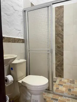 a bathroom with a toilet and a shower at Hotel Casa Campestre in Jardin
