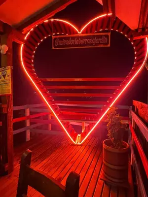 a heart neon sign on the side of a deck at Hotel Casa Campestre in Jardin