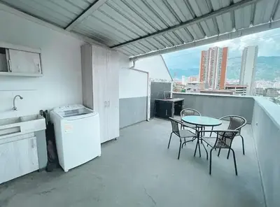 a kitchen with a table and chairs on a balcony at Beautiful Duplex Apt in Cabañas Bello Antioquia in Medellín