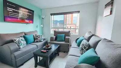 a living room with a couch and a table at Beautiful Duplex Apt in Cabañas Bello Antioquia in Medellín