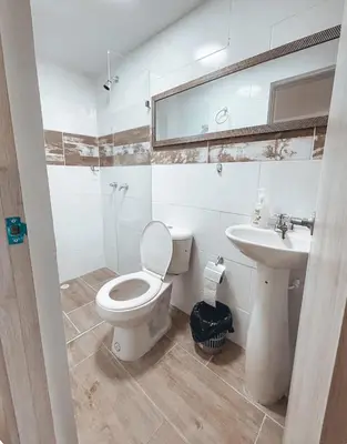 a bathroom with a toilet and a sink at Beautiful Duplex Apt in Cabañas Bello Antioquia in Medellín