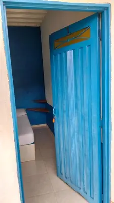 a blue door in a room with a toilet at Centro Turístico Paraíso del Nare in Alejandría