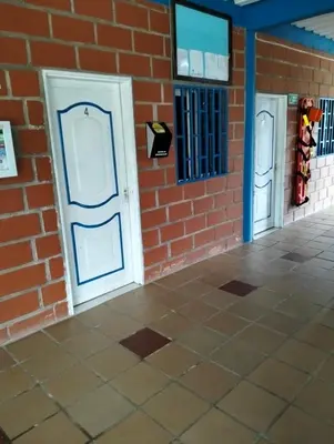 a brick wall with two doors on the side of a building at Centro Turístico Paraíso del Nare in Alejandría
