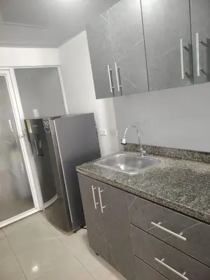 a kitchen with a sink and a refrigerator at Apartaestudio Amoblado Chinchina Caldas in Chinchiná