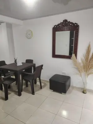 a dining room with a table and a mirror at Apartaestudio Amoblado Chinchina Caldas in Chinchiná