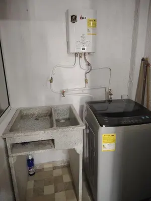 a bathroom with a sink and a water heater at Apartaestudio Amoblado Chinchina Caldas in Chinchiná