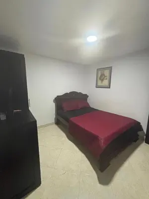 a bedroom with a bed with a red blanket at Hospedaje Doña Blanca 3 in Envigado