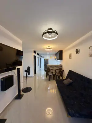 a living room with a couch and a dining room at Comfortable House in Mariquita