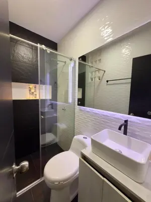 a bathroom with a toilet and a sink and a shower at Comfortable House in Mariquita