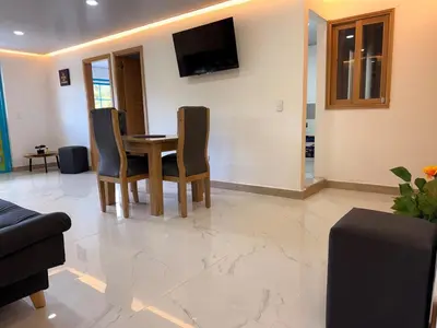 a living room with a table and chairs at Apartamento céntrico, Guatape, cerca al malecon in Guatapé