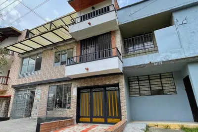 an apartment building with yellow doors and a balcony at Edificio Casa Anita in Medellín