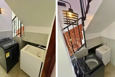 a bathroom with a washer and dryer and a staircase at Edificio Casa Anita in Medellín