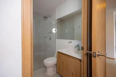 a bathroom with a toilet and a sink at Modern apartment - Pool, Gym, and Coworking Space in Envigado