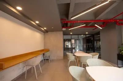 a restaurant with white tables and white chairs at Modern apartment - Pool, Gym, and Coworking Space in Envigado