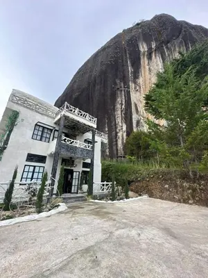 a building on the side of a mountain at templo de piedra refugio espiritual in Guatapé