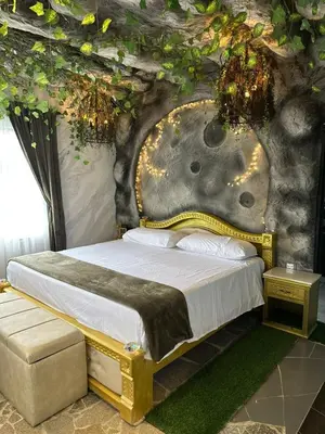 a bedroom with a bed in a room with a wall at templo de piedra refugio espiritual in Guatapé