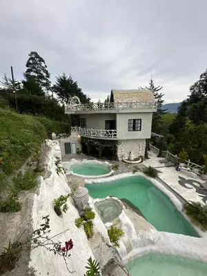 a house with a swimming pool in front of it at templo de piedra refugio espiritual in Guatapé