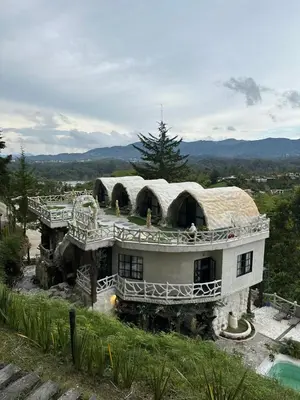 a large house with a roof on top of it at templo de piedra refugio espiritual in Guatapé