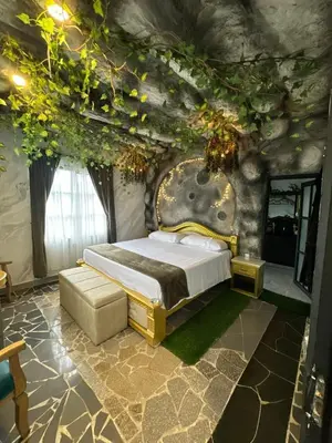 a bedroom with a bed in a stone wall at templo de piedra refugio espiritual in Guatapé