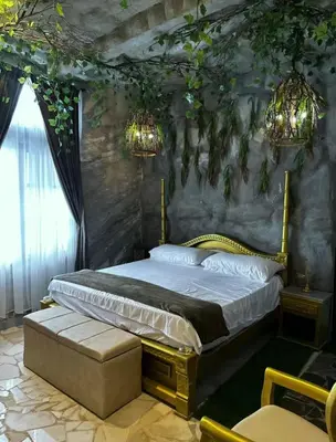 a bedroom with a king sized bed and chandeliers at templo de piedra refugio espiritual in Guatapé