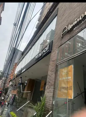 a store with a sign on the side of a building at Apartamento central in Sabaneta