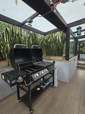 a barbecue grill on a patio with plants at Modern Apt in Poblado with Private Terrace & Gym in Medellín