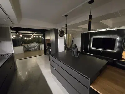a kitchen with a black counter top and a tv at Modern Apt in Poblado with Private Terrace & Gym in Medellín
